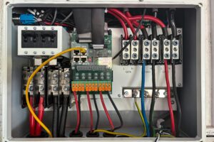 Inside view of an electrical control panel showing circuits and connections.